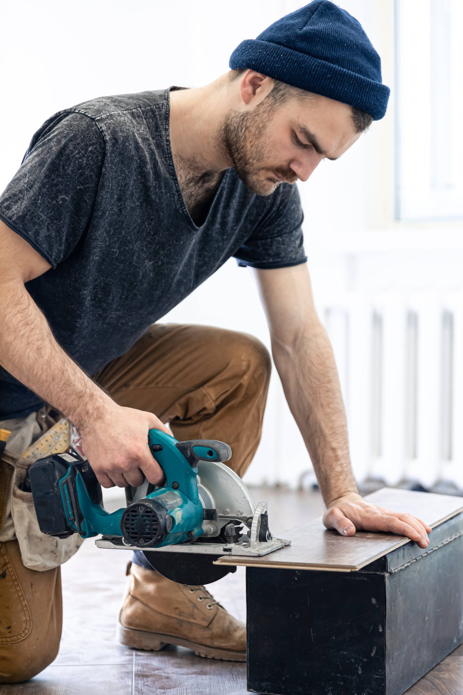 Circular Saw, carpenter using a circular saw for wood. Building contractor worker using hand held worm drive circular saw to cut boards on a new home constructiion project.