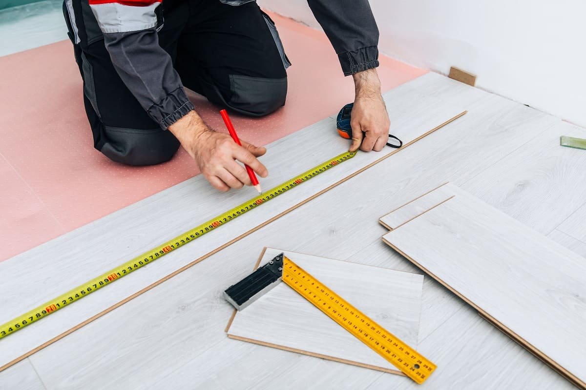 man-installing-new-laminated-wooden-floor-2025-03-18-15-19-53-utc